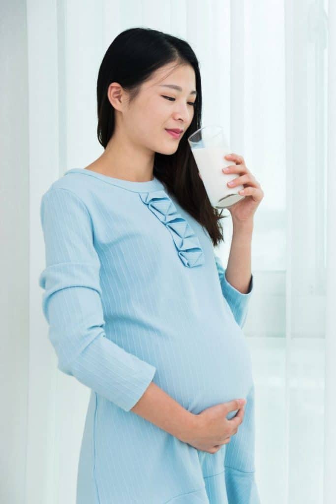 Pregnant woman drinking smoothie