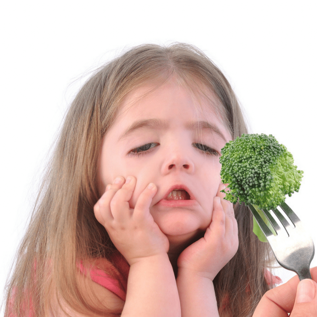 picky eater grimacing at broccoli